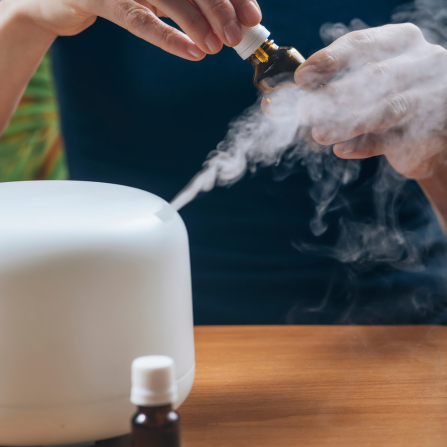 Une femme utilise un diffuseur d'huiles essentielles